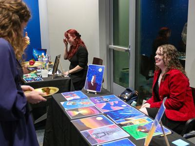 Riley Jones displays her paintings. (Photo by Chariti Mealing, CIU student photographer) 